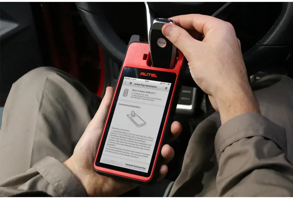 Autel KM100 programmer reading a car key