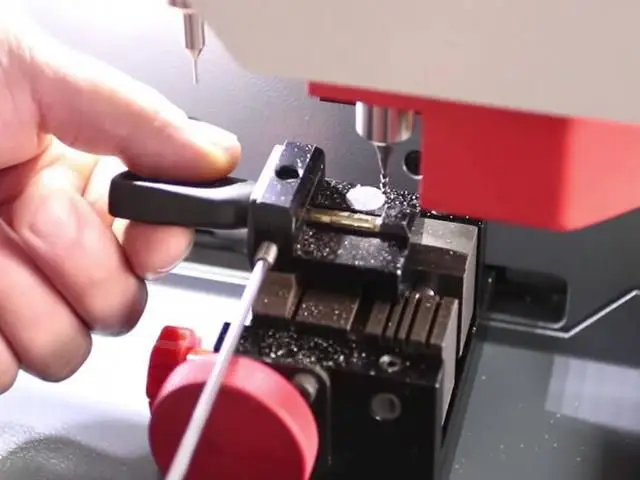 A key is being cut on key cutting machine