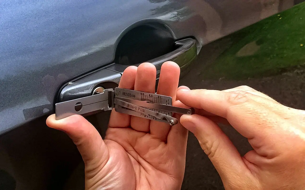 Opening car door lock with Lishi tool.