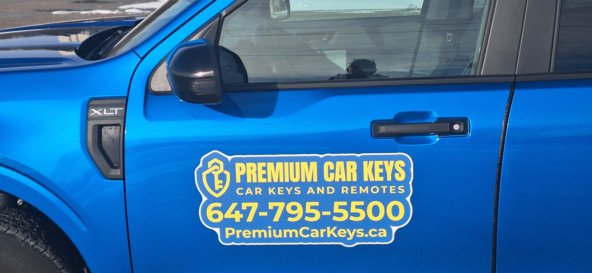 Blue Ford Maverick drivers door with Premium Car Keys logo.